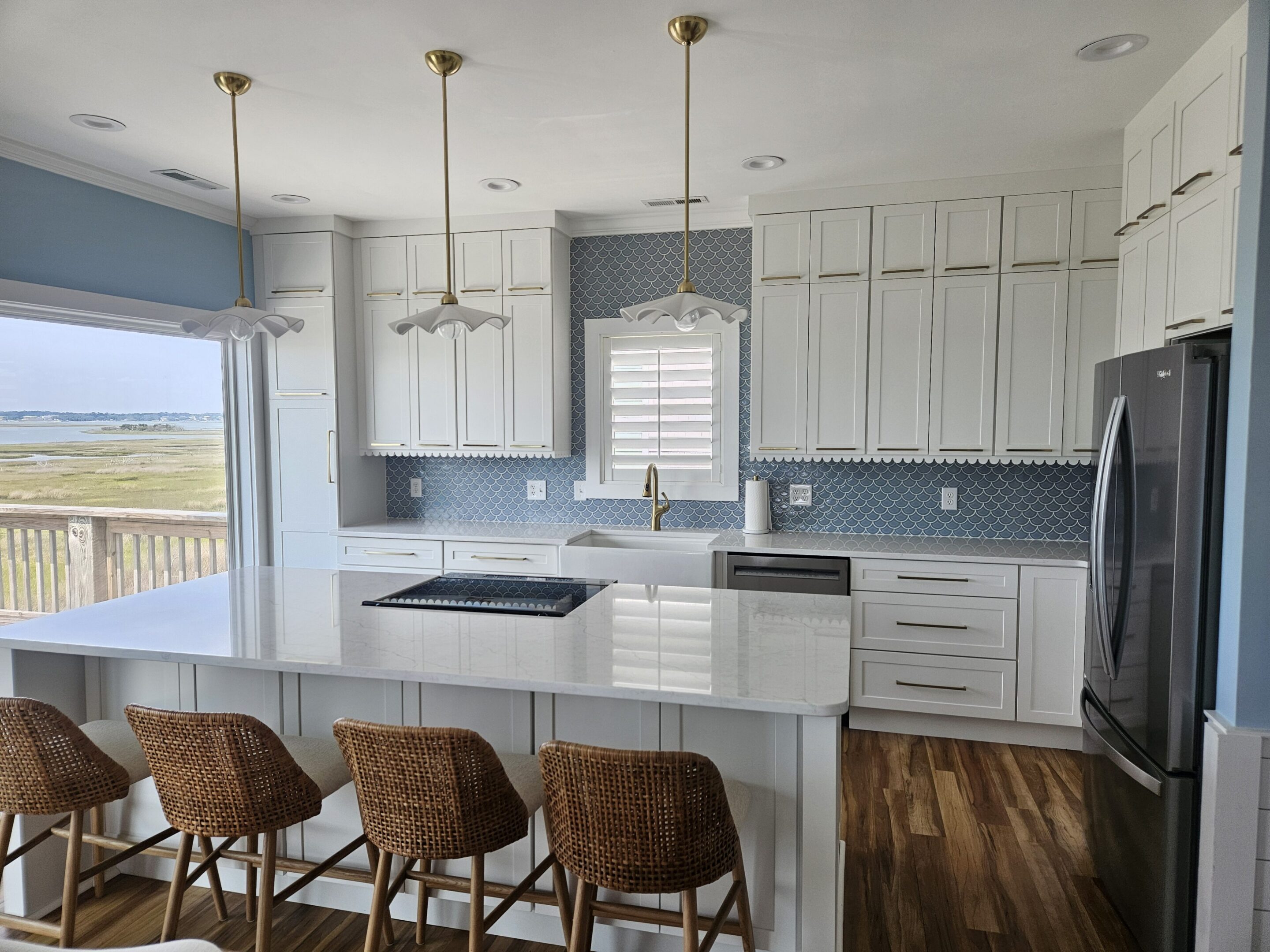White coastal kitchen with island and stools