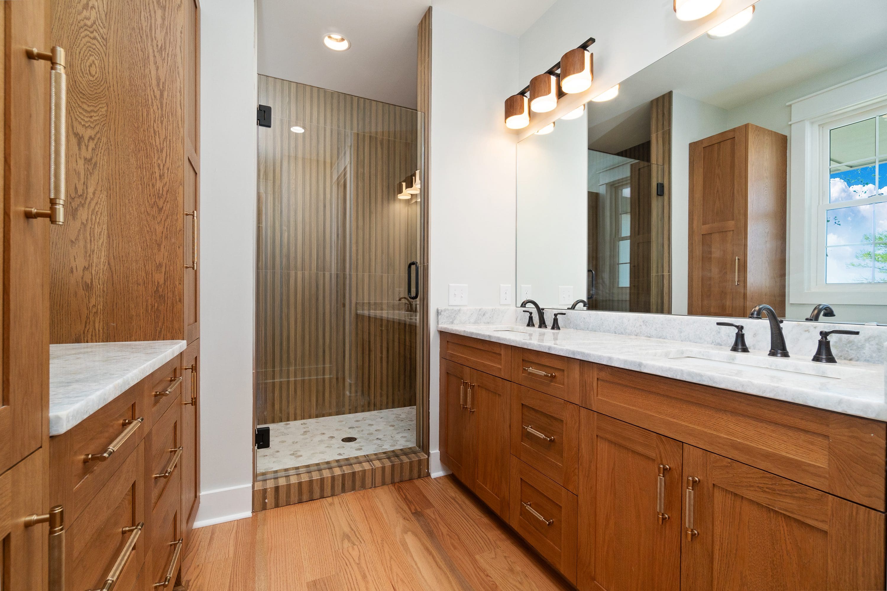 Modern bathroom with double vanity and glass shower