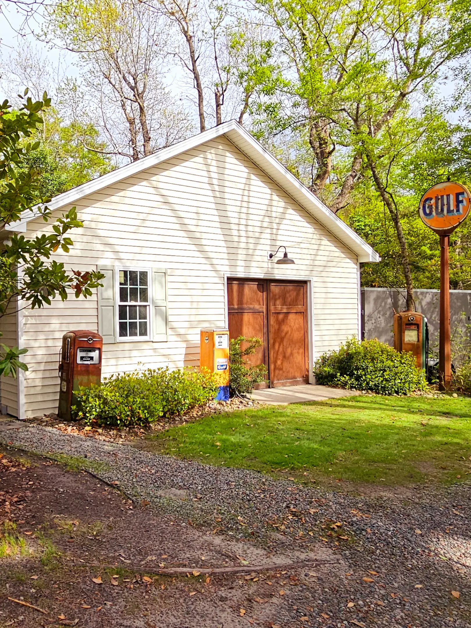 White garage with vintage Gulf gas pumps