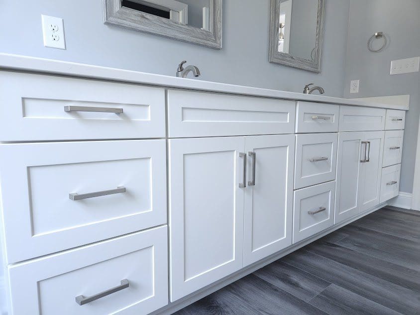 White bathroom cabinets with silver handles