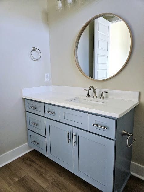 Stylish bathroom with wooden floor