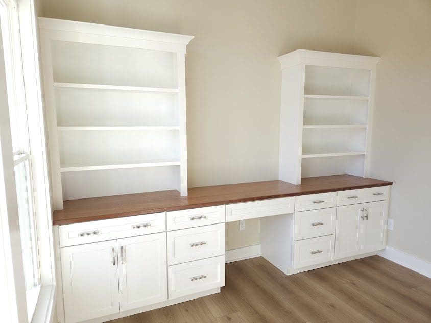 White built-in cabinets with wooden countertop