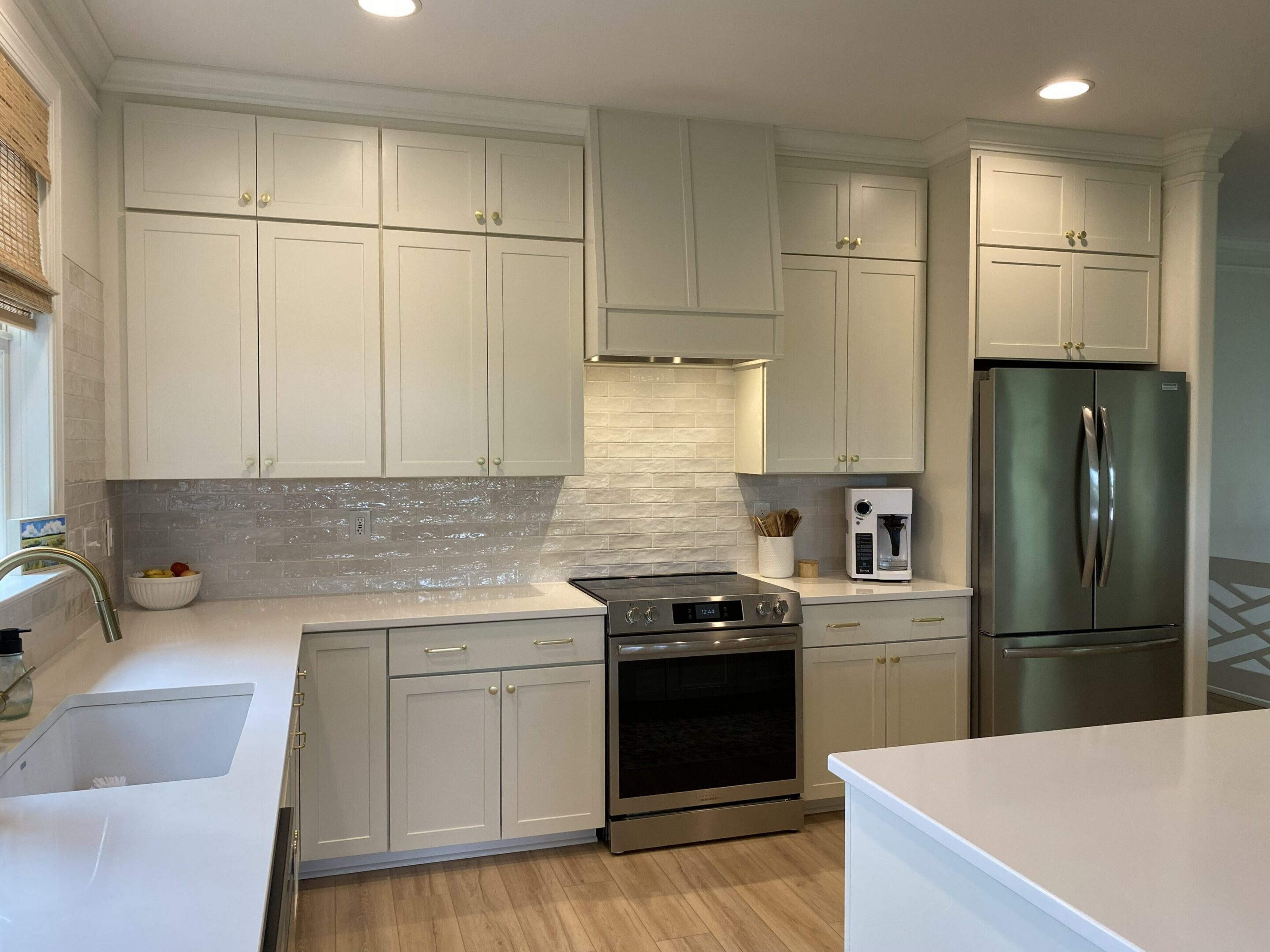 Bright kitchen featuring stainless steel fridge.